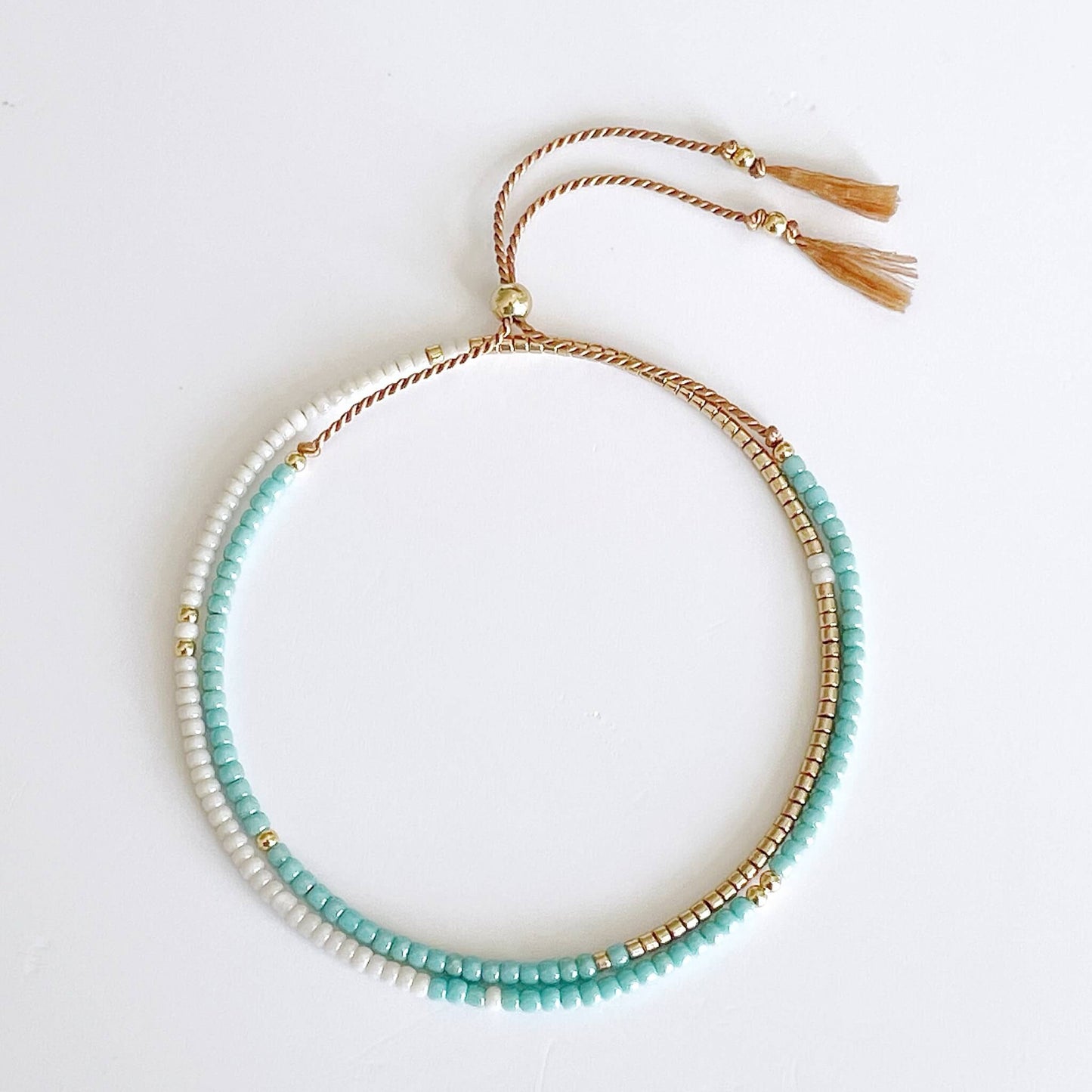 Aqua and white beaded double wrap bracelet with gold fill accents on silk cord