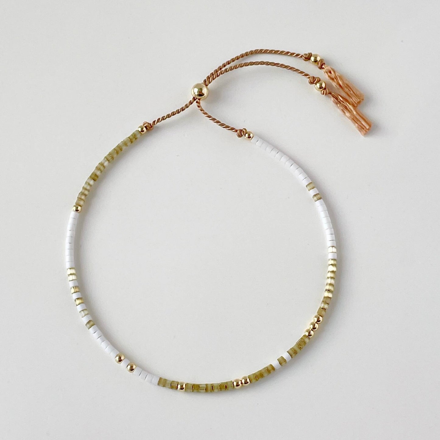 Bali beaded bracelet with tiny beige and white glass beads and gold fill accents