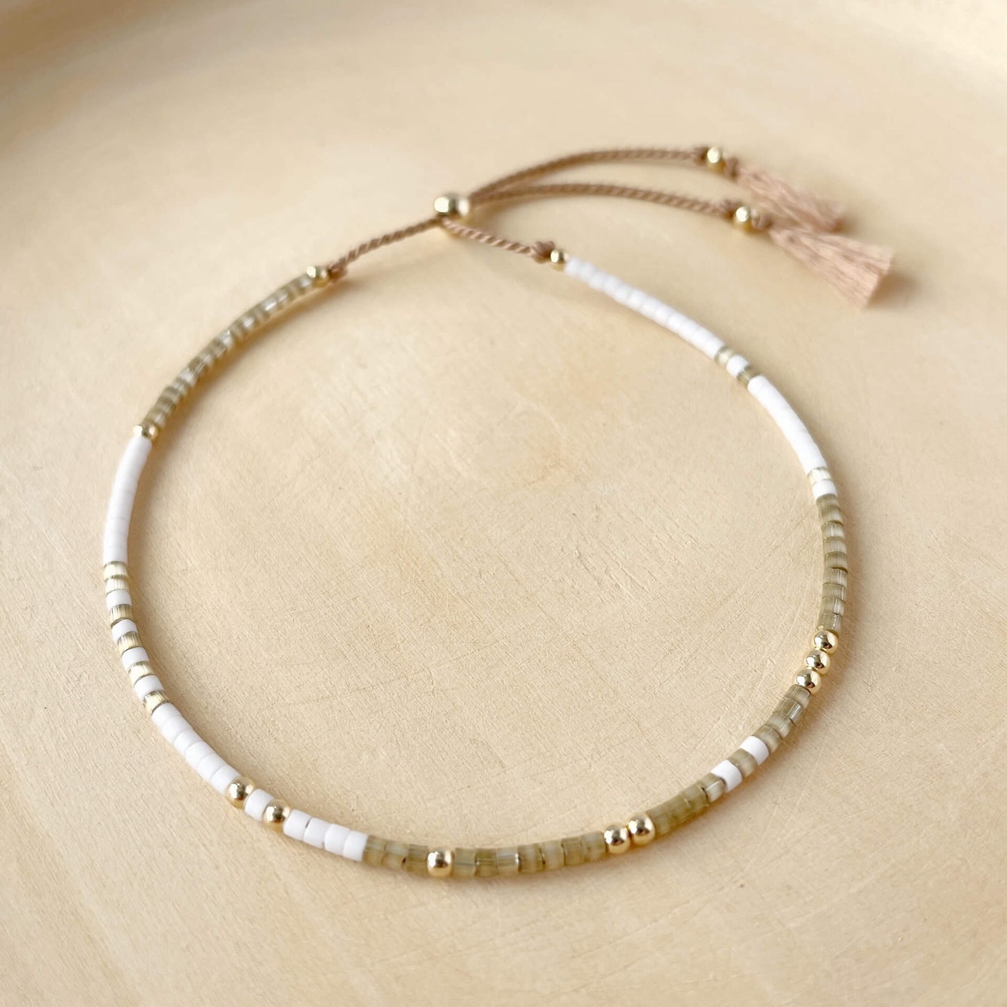 Dainty beaded silk bracelet with tiny beige and white glass beads and gold fill accents