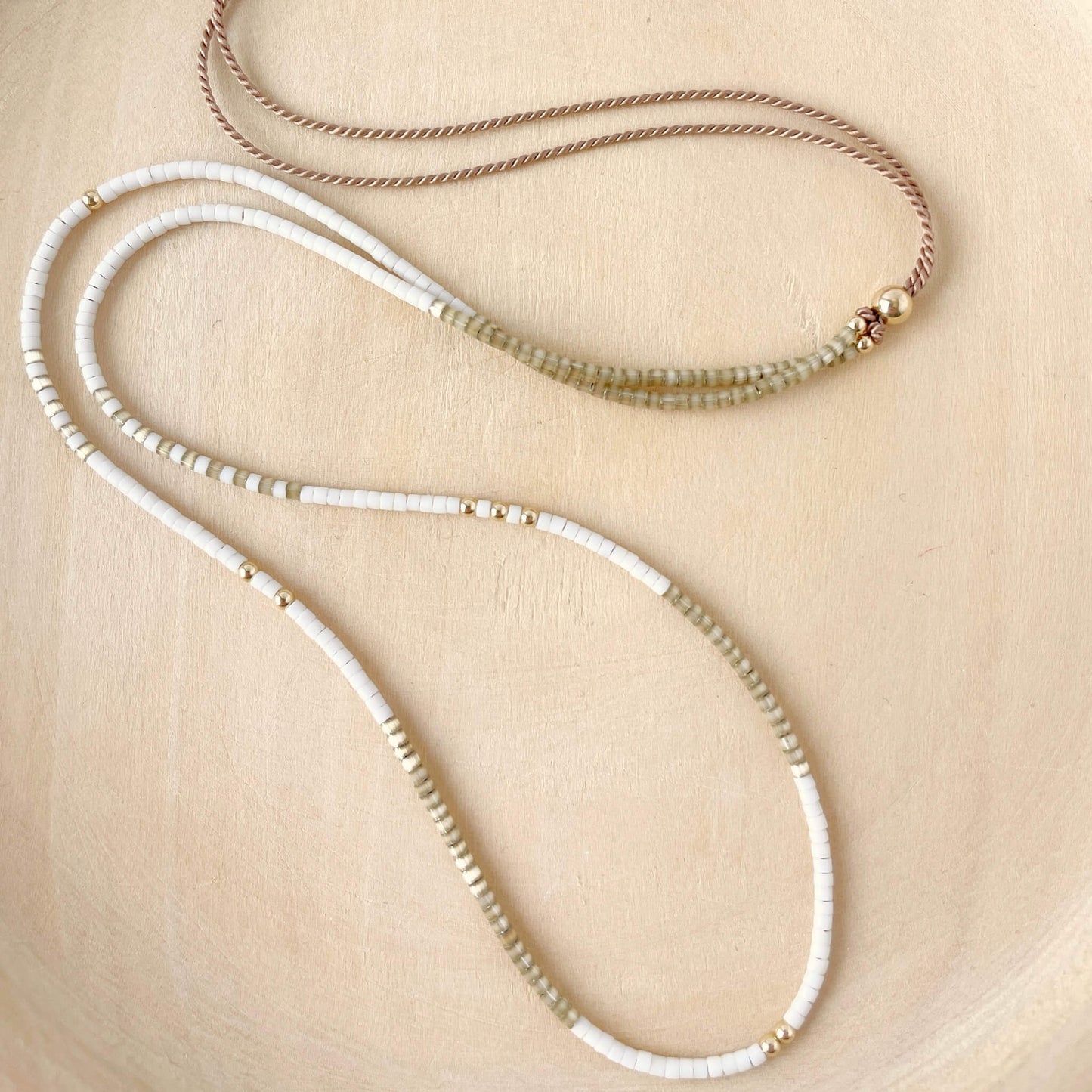 close up of tiny miyuki beaded cream and taupe beaded necklace