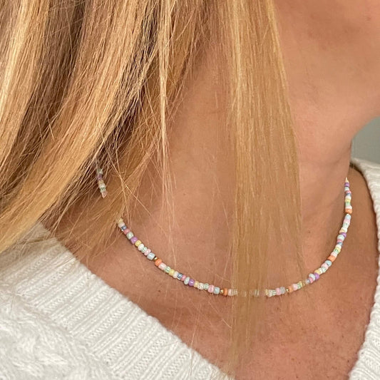Sorbet colour palette beaded necklace with pastel coloured glass 3mm beads with gold fill accent beads, clasp and extender chain worn around the neck