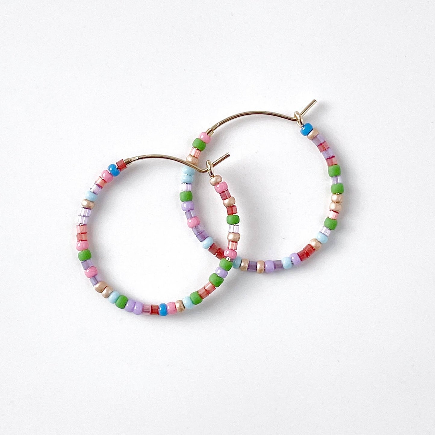 14k gold filled hoop earrings with multicoloured glass beads in pink, blue, red, green, and lilac