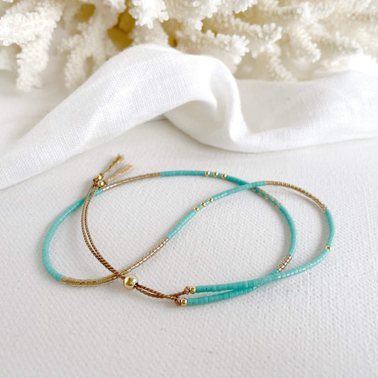 Delicate Double wrap bracelet with turquoise and gold beads and gold fill accents infant of a piece of coral