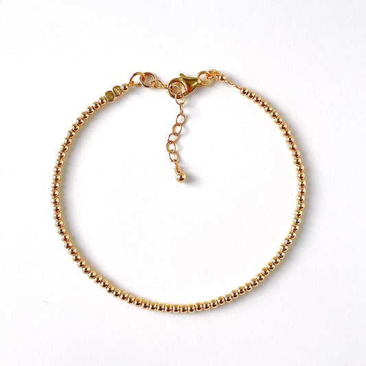 Minimalist 14k gold filled bead bracelet with 2mm beads with a lobster clasp and extension chain.