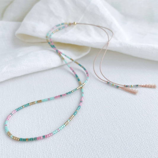 delicate beaded necklace with Pink, green and gold tiny glass beads on a pale pink silk cord with gold accents and adjustable length