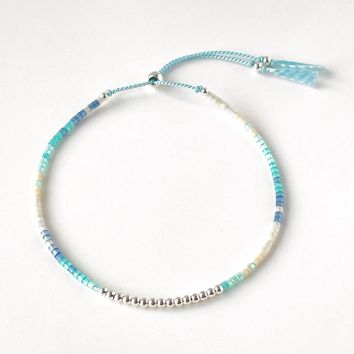 Ives beaded bracelet with blue, aqua and beige glass beads and sterling silver accents