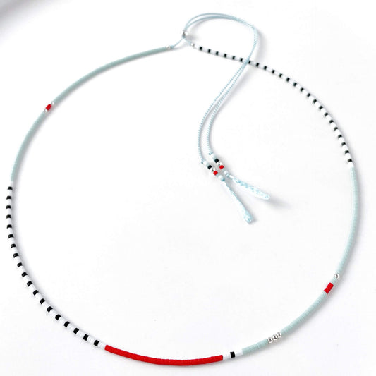 Sterling silver slider and colourful nautical glass beads detail on adjustable pale blue silk cord