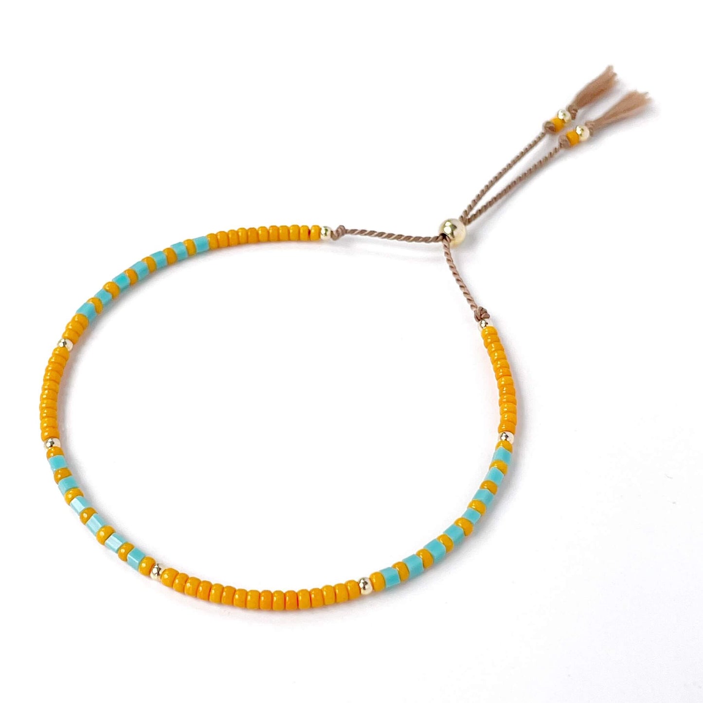 Beaded bracelet with orange and turquoise beads on a white background