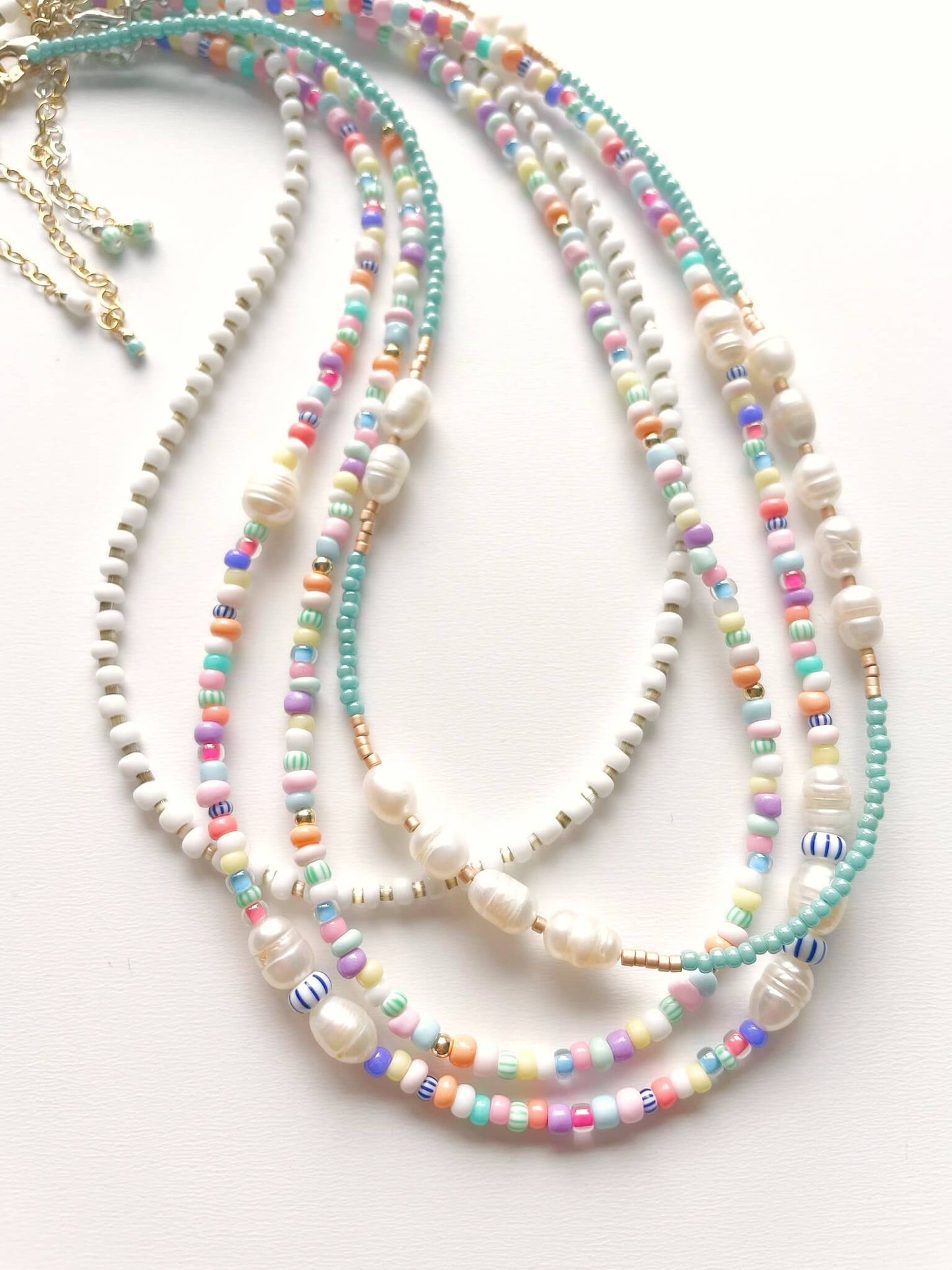 4 colourful beaded necklaces laid out together