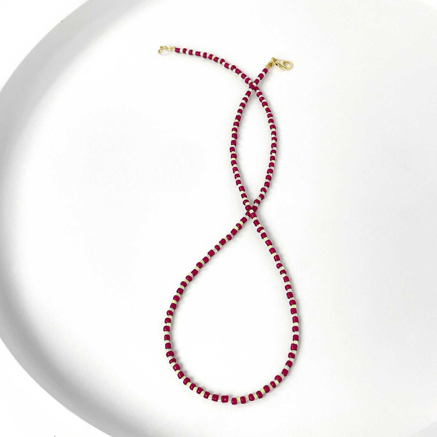 Beaded necklace with burgundy and citrus yellow glass beads and gold filled clasp