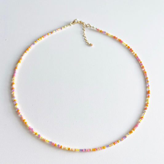 Vibrant beaded gold necklace with orange, pink, yellow and purple Miyuki glass beads and gold fill accents