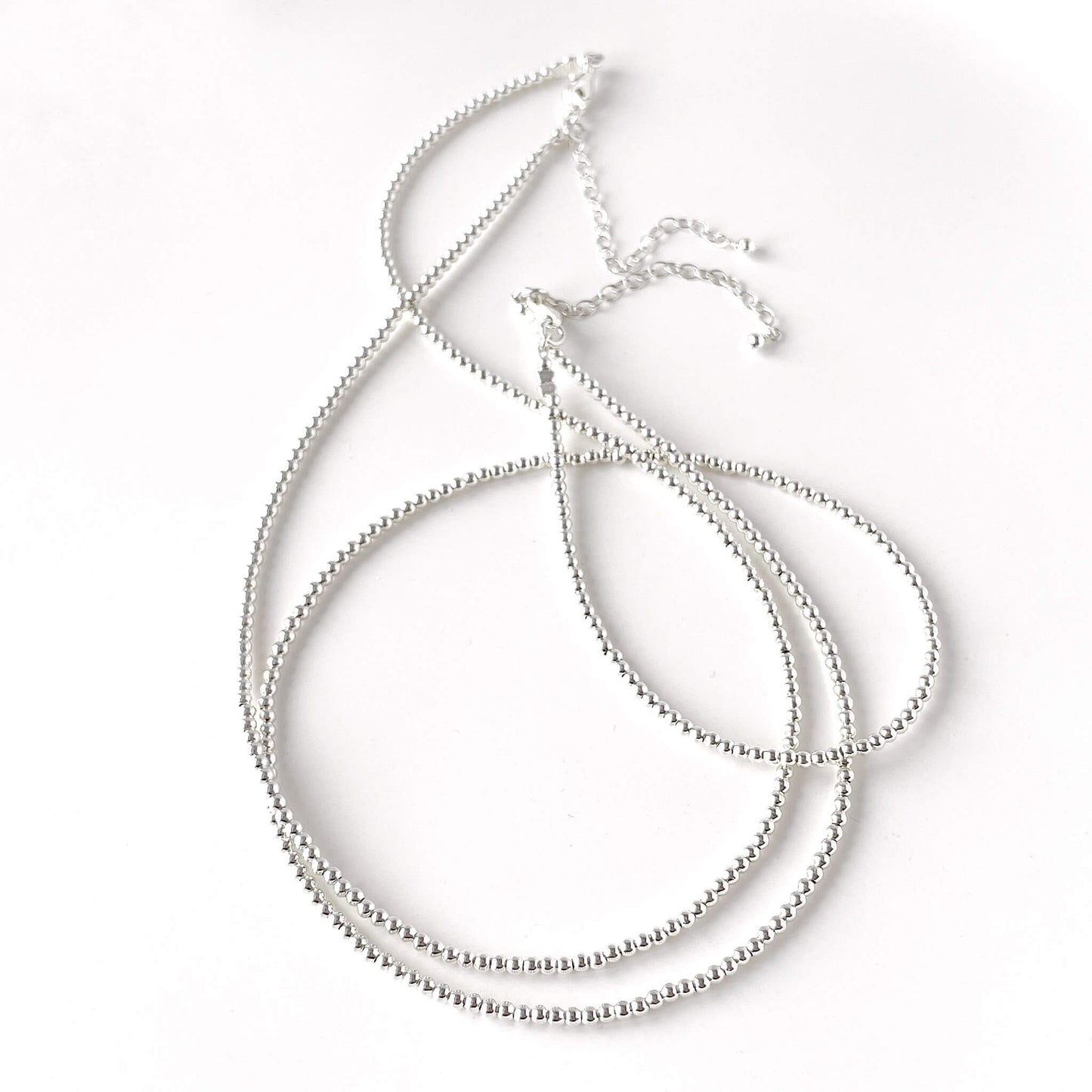 2 sterling silver beaded necklaces displayed against a white background