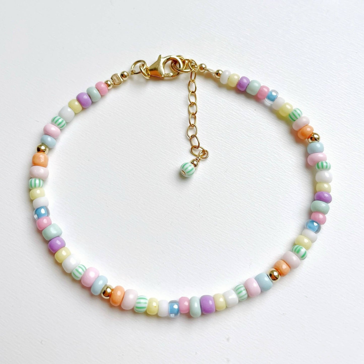 Boa Vista bracelet with soft-coloured Miyuki glass beads in pink, blue, green, yellow, peach, white and lilac and gold fill accents