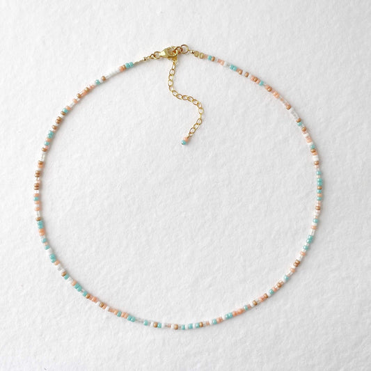 14k gold filled lobster clasp and randomly arranged aqua, peach and gold glass beads on coastal necklace