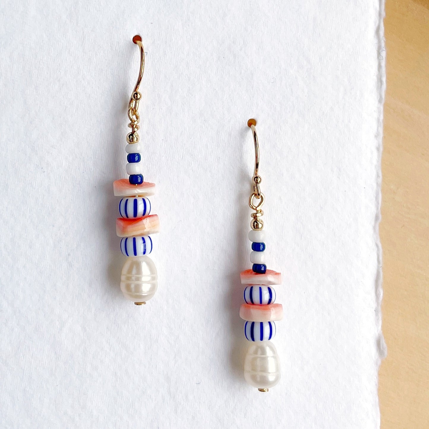 Gold fill drop earrings with freshwater pearls, orange and white shell, and glass beads