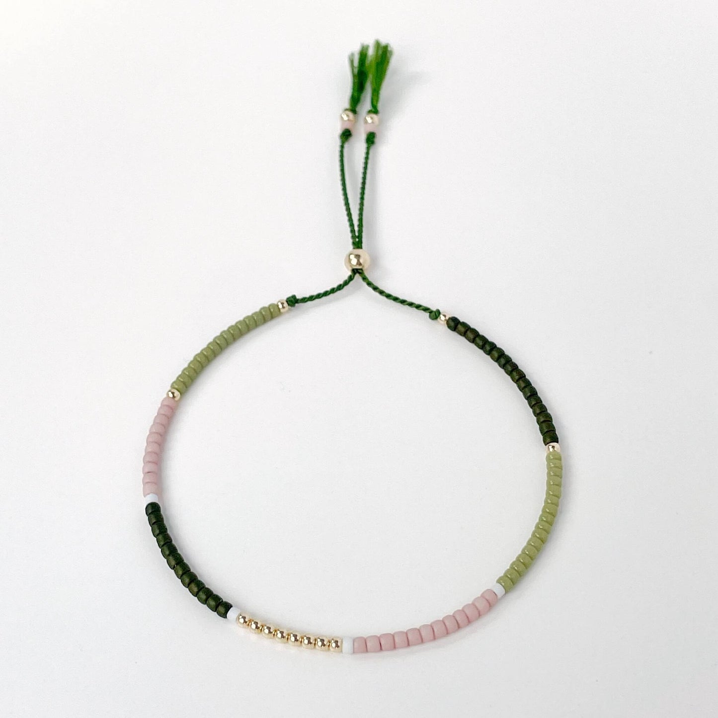 Sedona adjustable bracelet with dusty pink, green, white, and dark olive Miyuki beads on olive silk cord with gold fill accents
