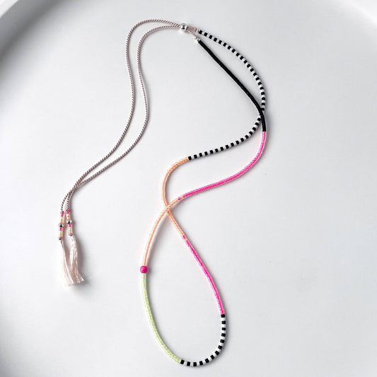 Sterling silver accent beads and vibrant neon glass beads detail on adjustable pink silk cord necklace
