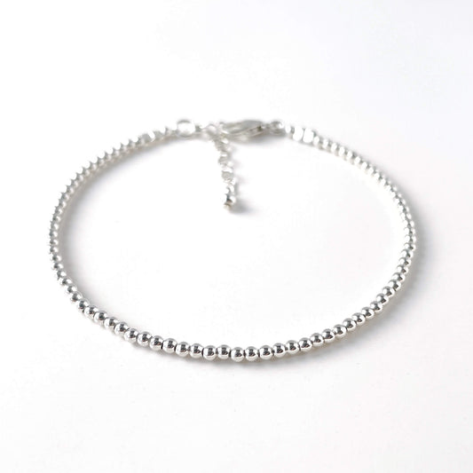 Silver beaded bracelet on a white background