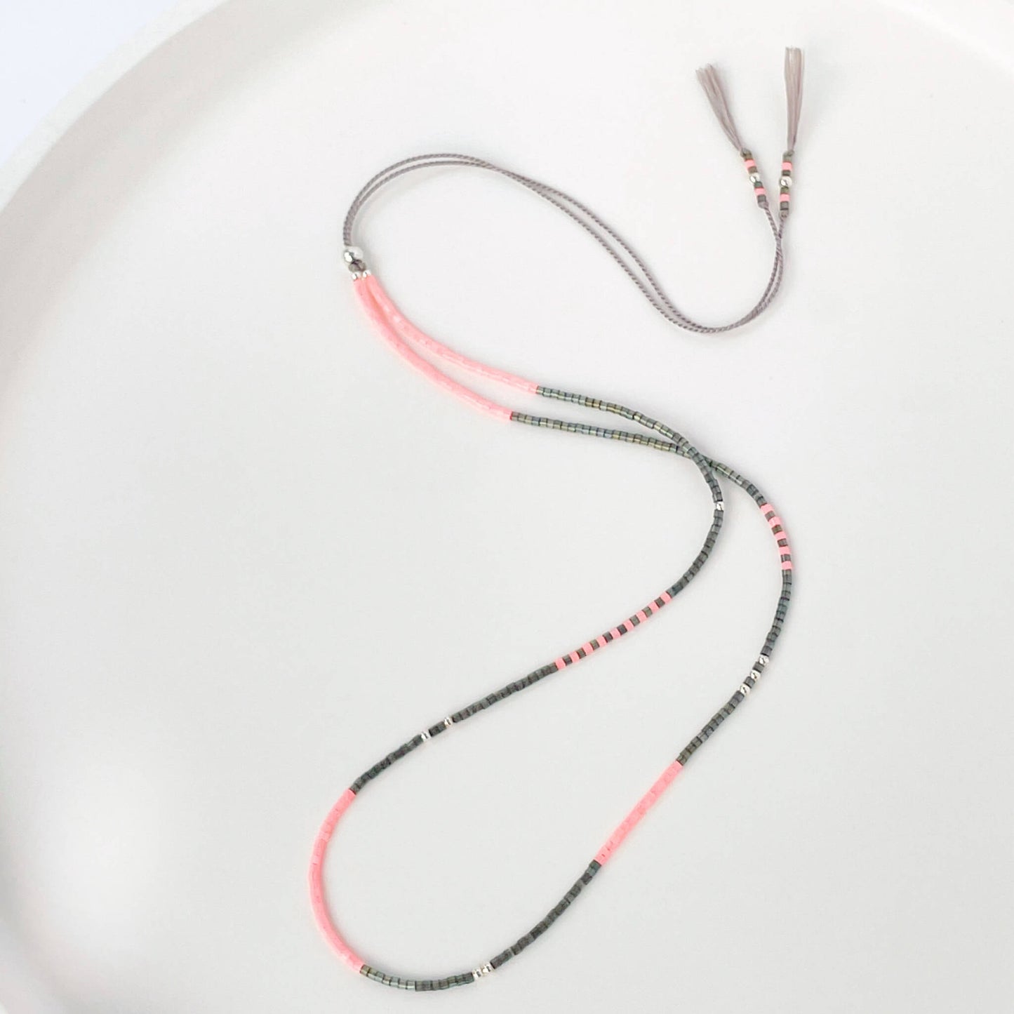 Dainty beaded necklace with grey and bright pink Miyuki beads on silk cord with sterling silver accents
