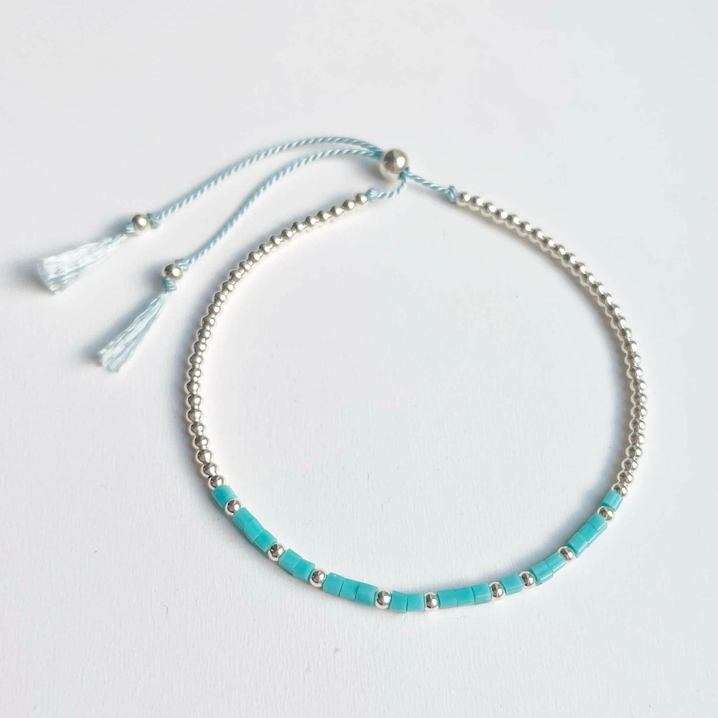 Silver Wild Beach bracelet with turquoise square glass beads and sterling silver accents on pale blue silk