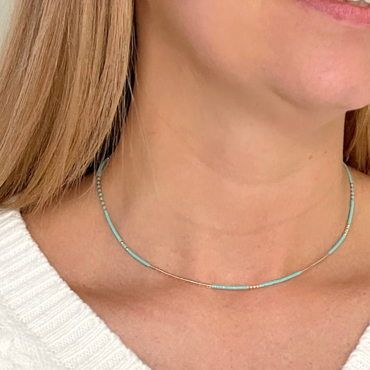 turquoise and gold bead necklace shown worn at adjustable lengths for layering or solo style