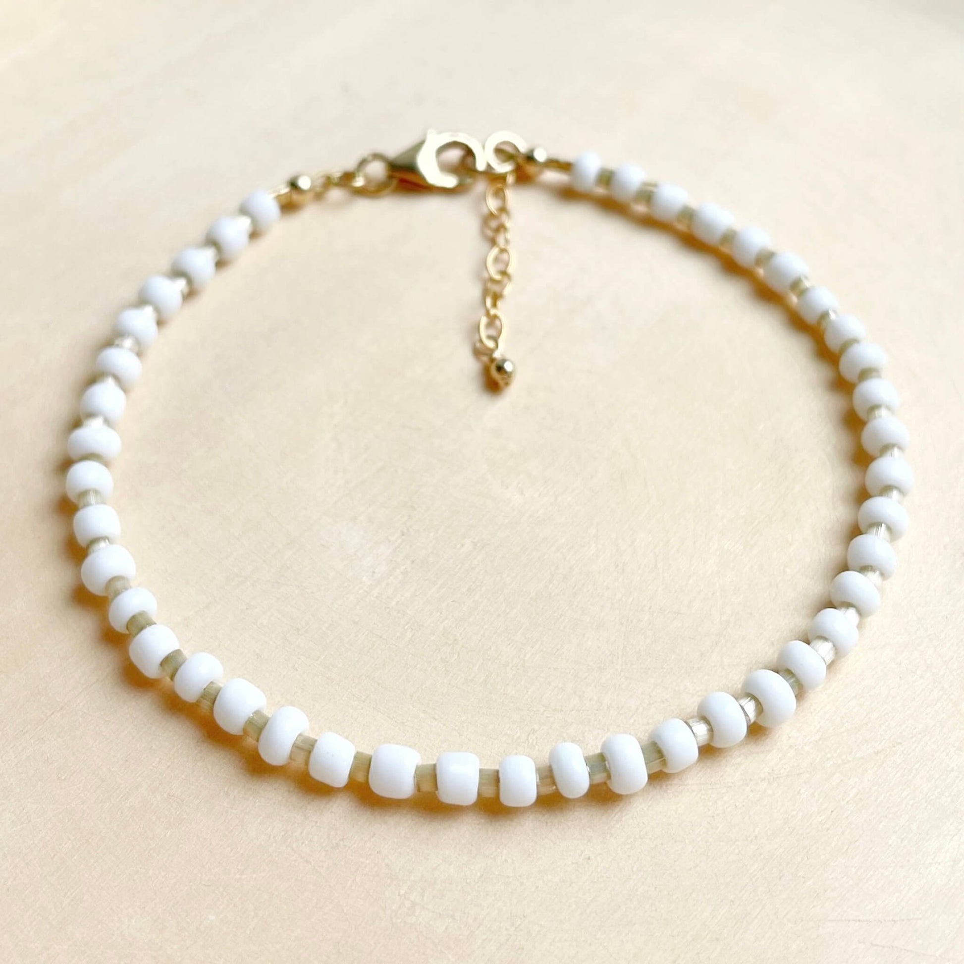 minimalist white beige and gold beaded ankle bracelet with gold clasp