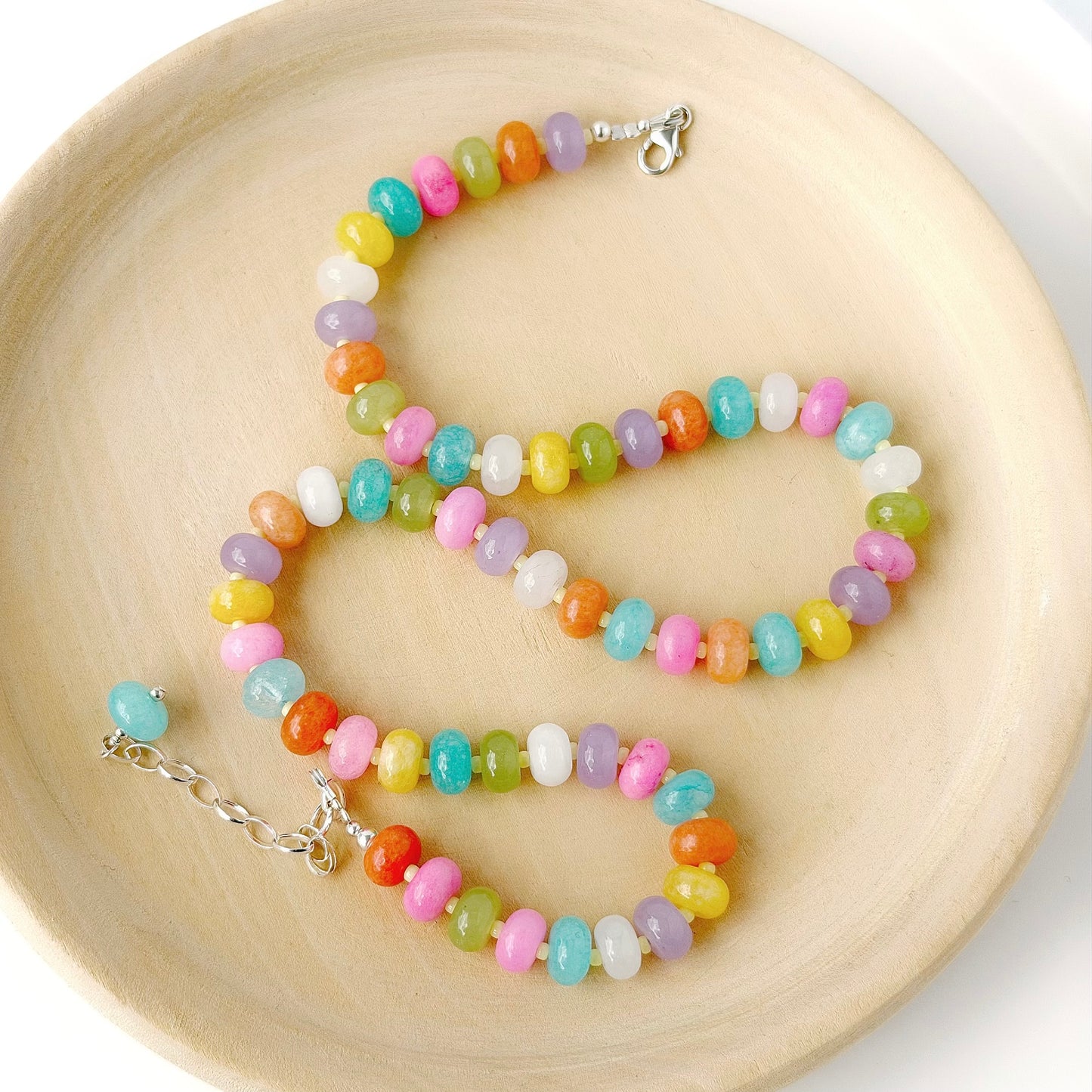 Colorful beaded necklace on a wooden surface