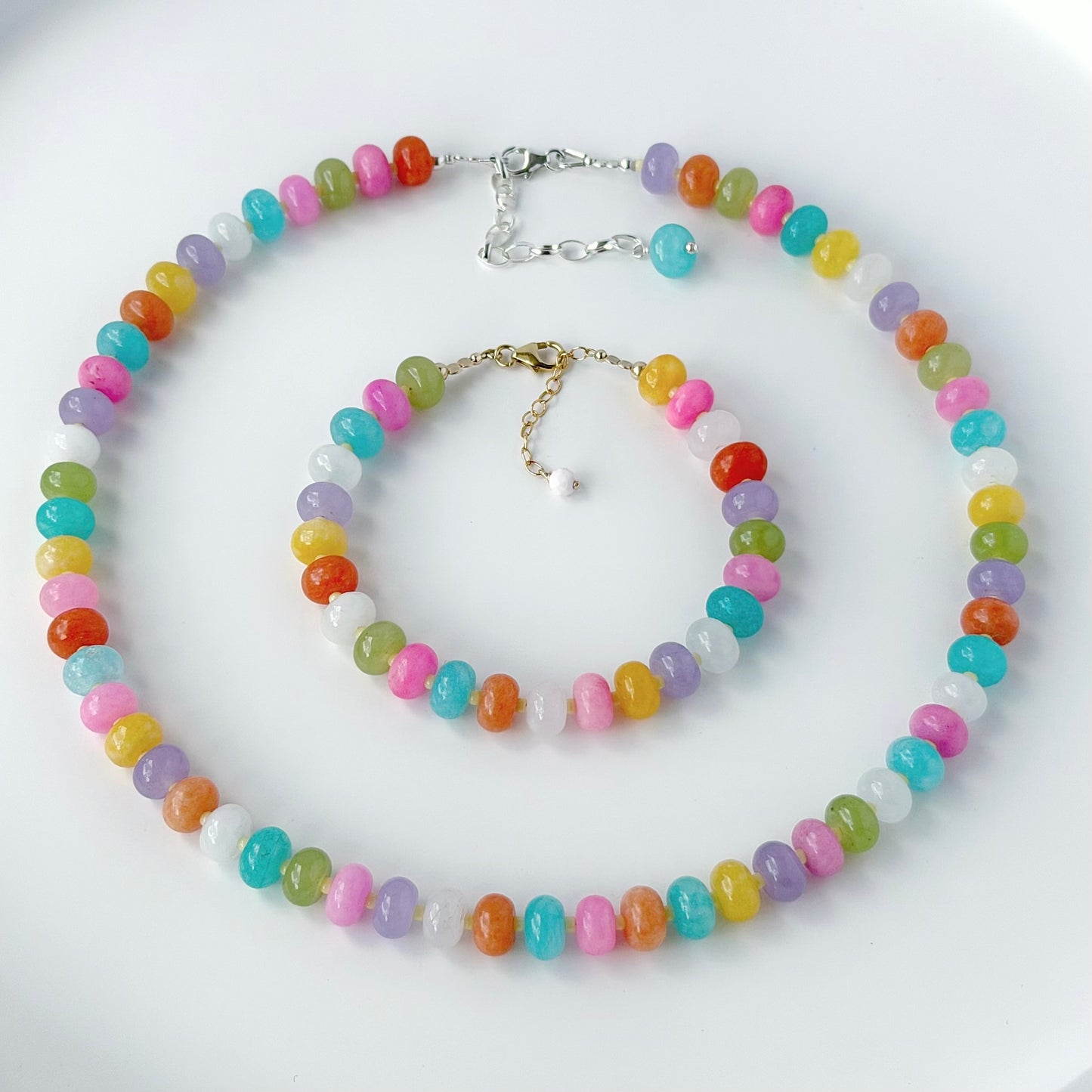 Colorful beaded necklace and bracelet set on a white background
