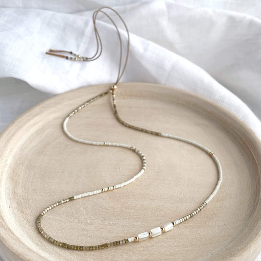 Minimal beaded necklace with taupe and off-white glass beads, mother of pearl and 14k gold fill accents on adjustable silk cord