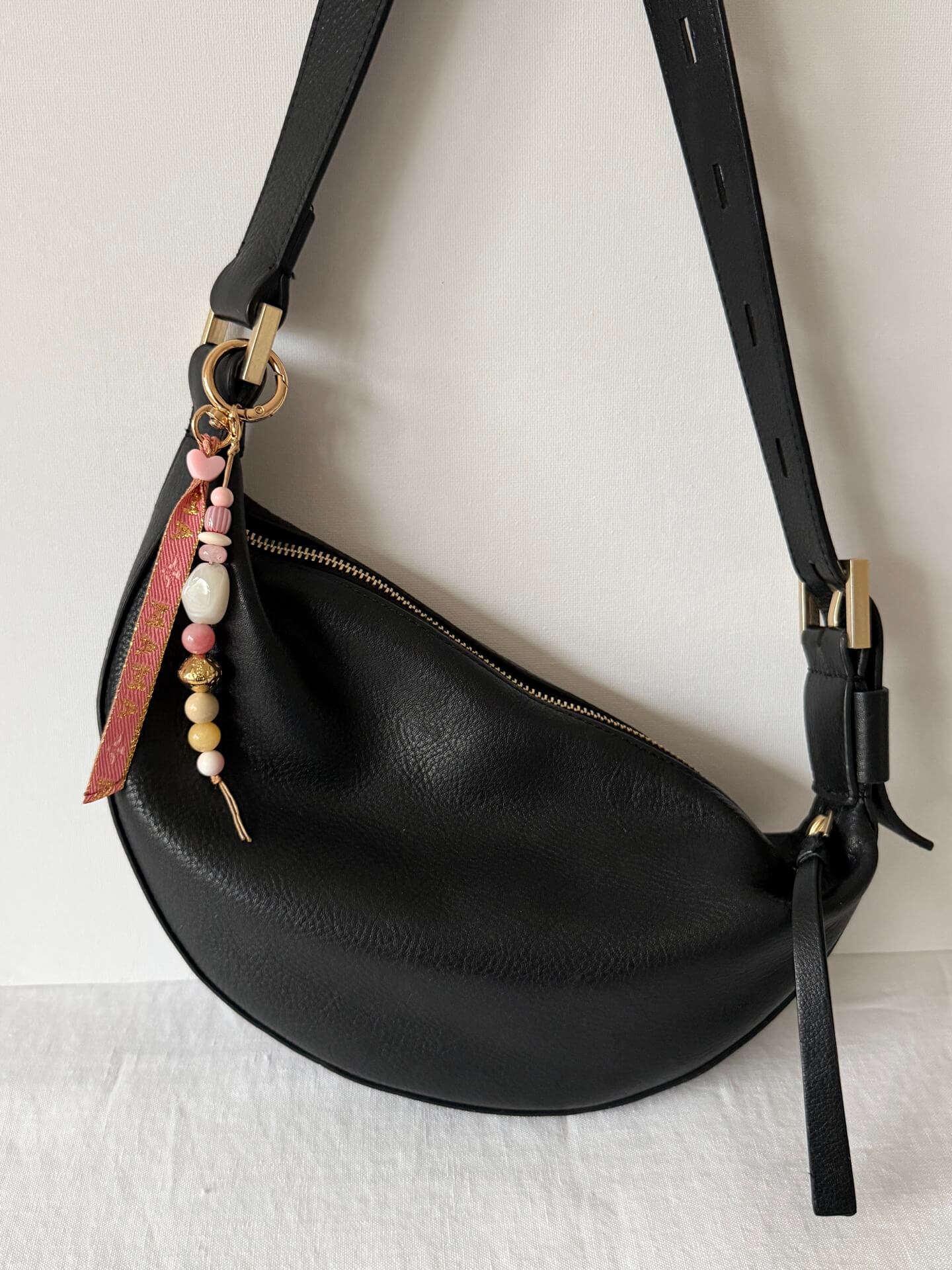 beaded bag charm with Momma printed ribbon and pink, yellow, white, red and gold beads on a bag against a white backdrop