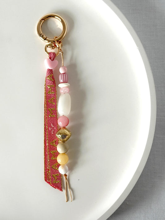 beaded bag charm with Momma printed ribbon and pink, yellow, white, red and gold beads