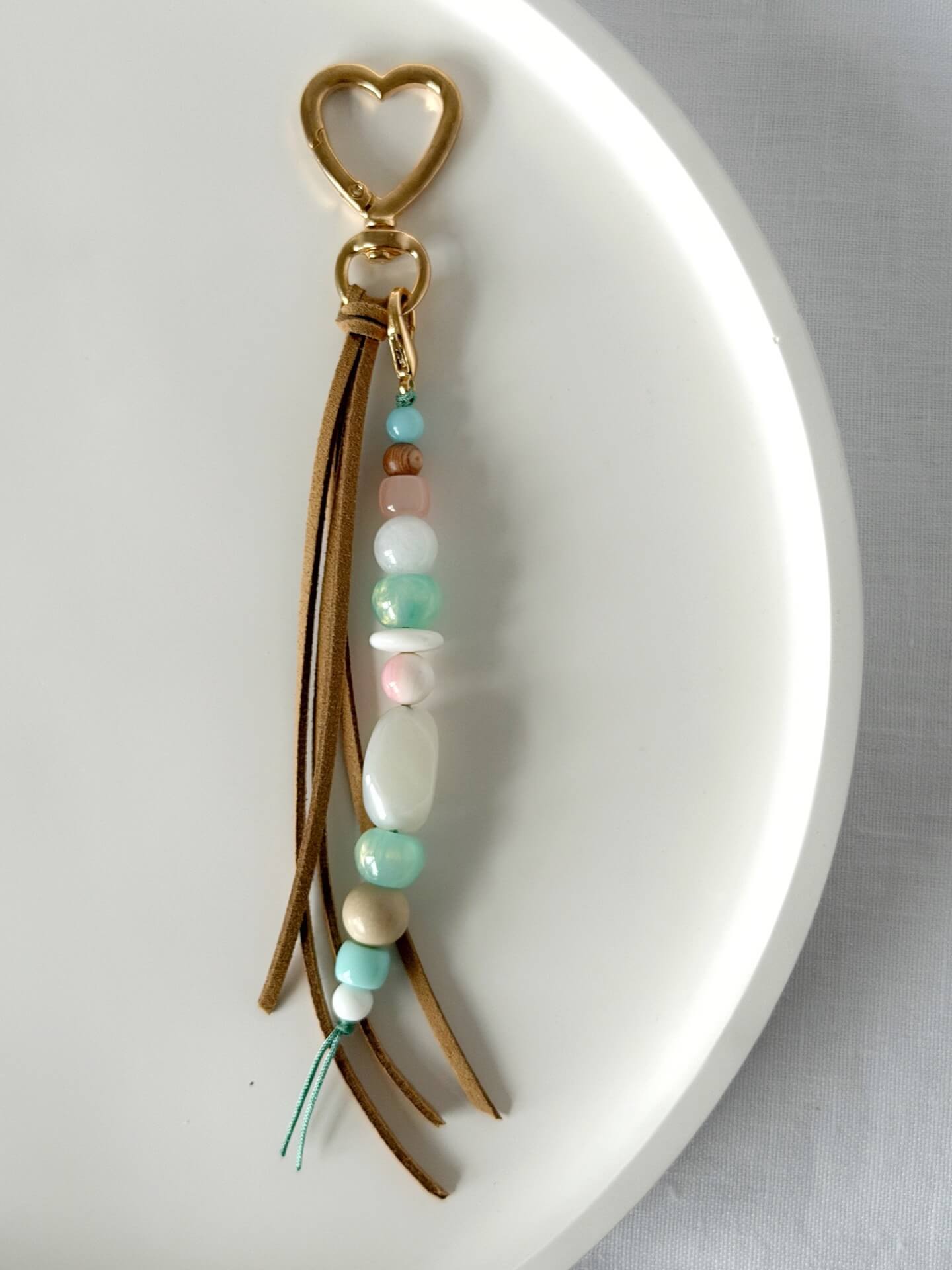faux suede tassel beaded bag charm with chunky beads in pink, aqua, white and beige in shell, resin, glass and wood