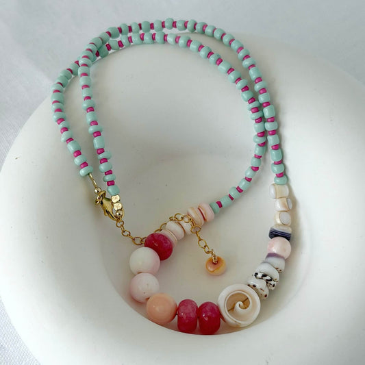 Necklace with multicolored beads on a white dish