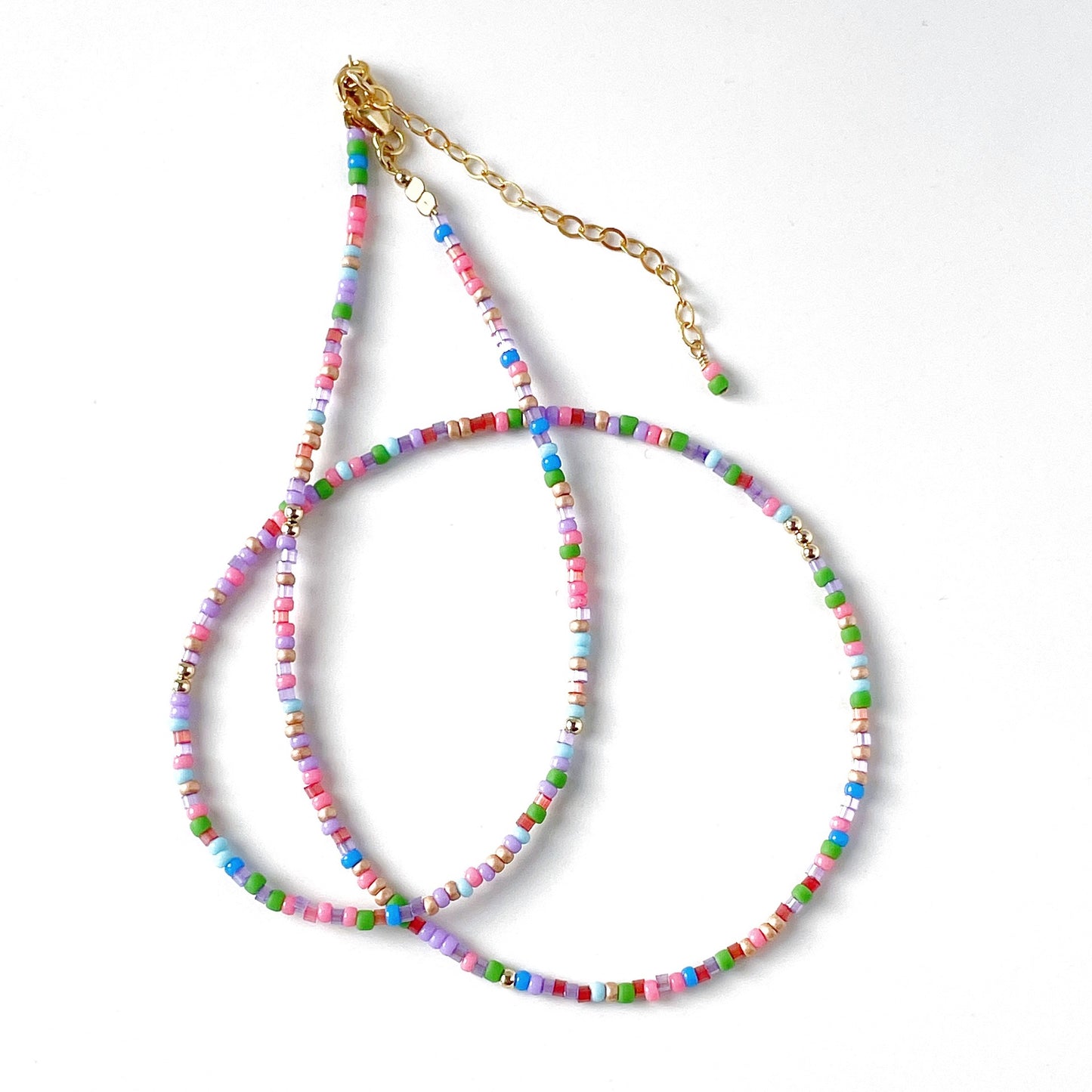 beautiful delicate beaded necklace with pink, blue, red, green and lilac beads with gold fill clasp and extension chain