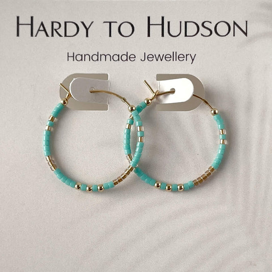 Fistral hoop earrings with turquoise and gold glass beads and gold fill accents