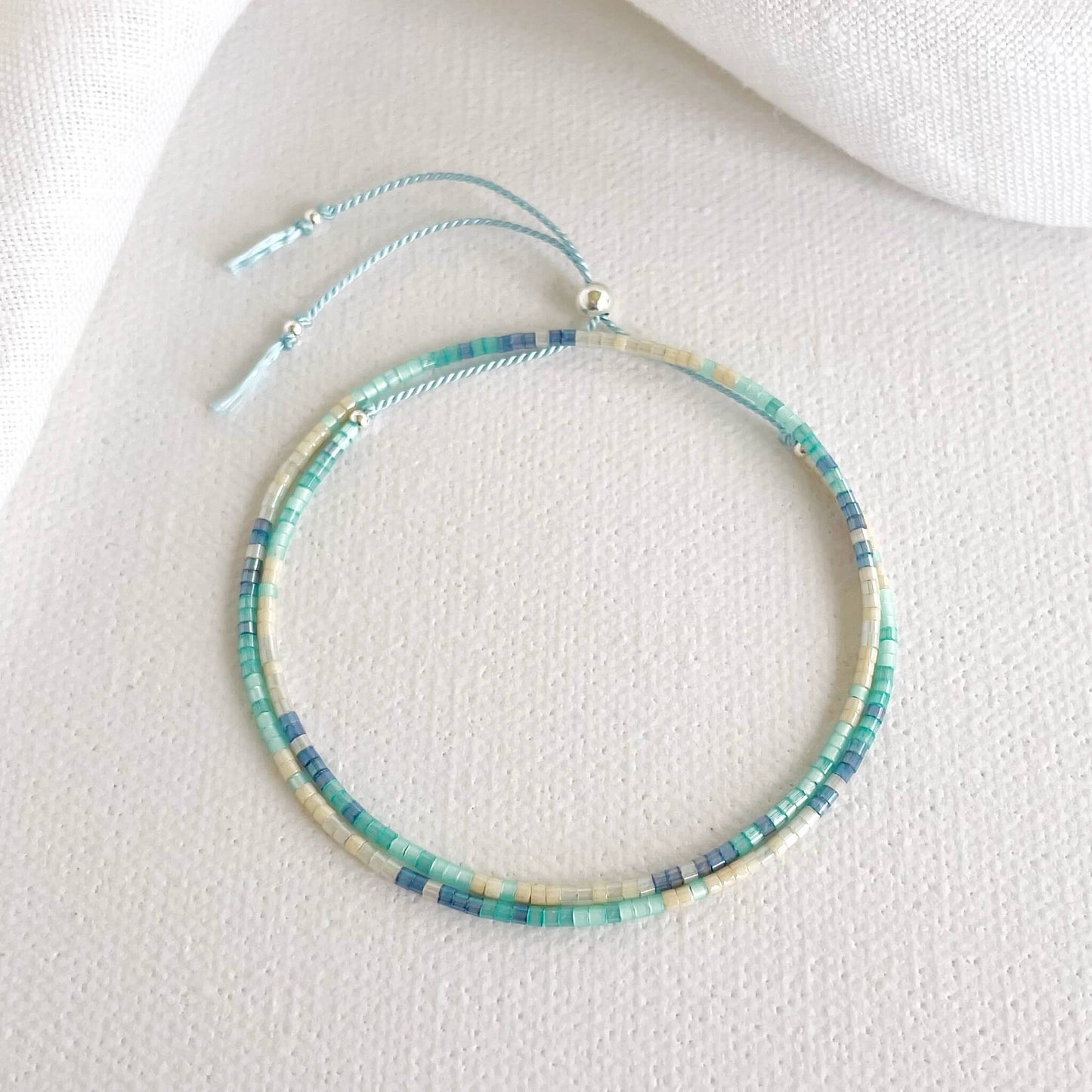 double wrap silk bracelet with aqua and blue glass beads and sterling silver accents