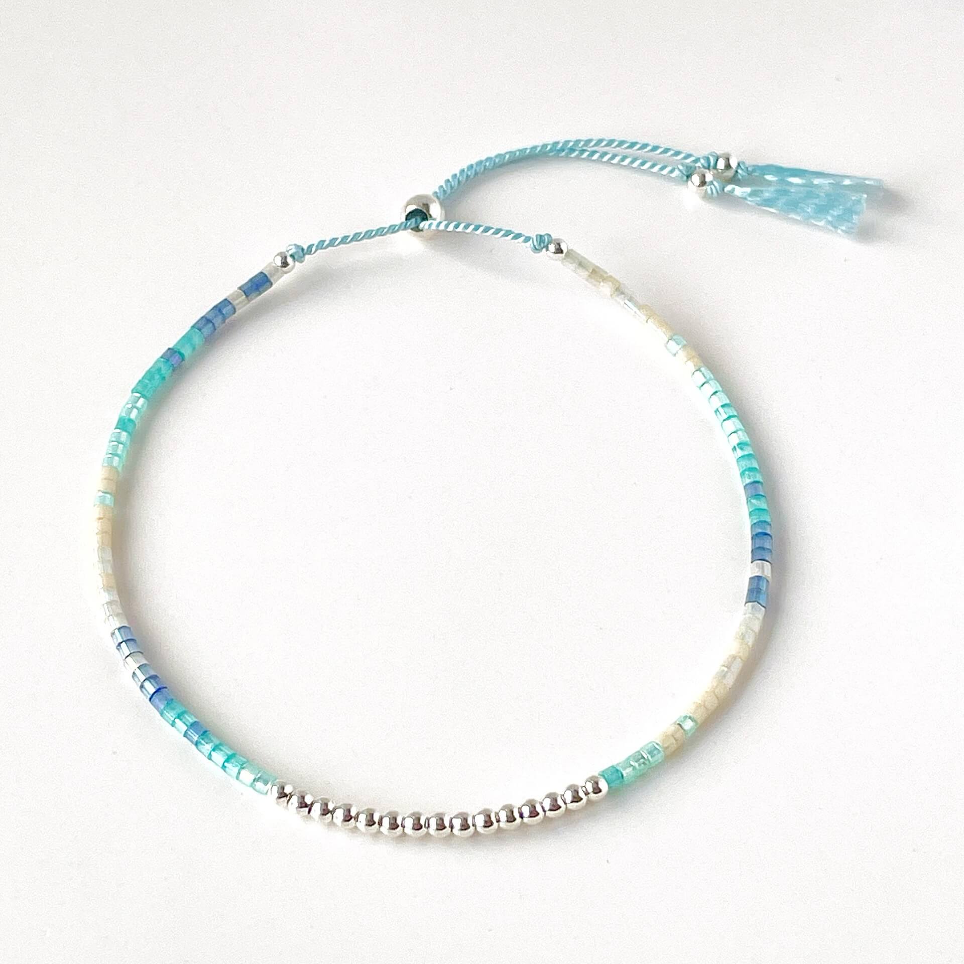 Ives beaded bracelet with blue, aqua and beige glass beads and sterling silver accents