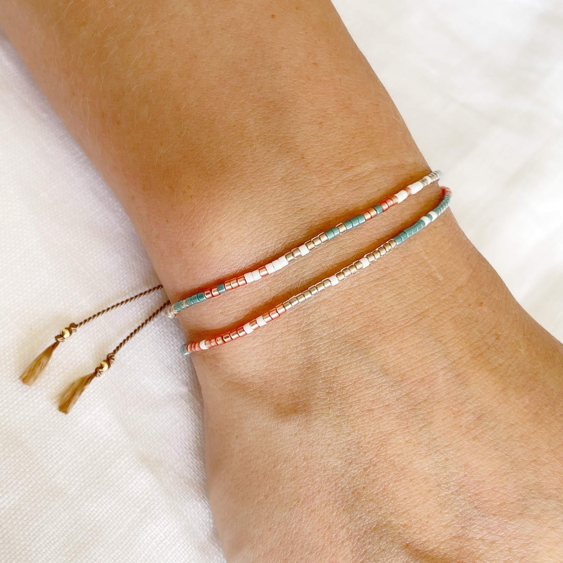 Fresh beaded double wrap bracelet in teal, golden orange and pale gold shown worn on wrist