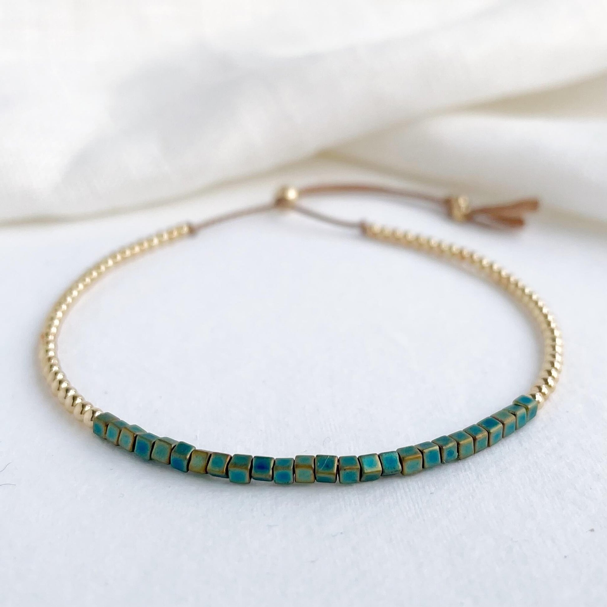 Liberty silk bracelet with teal Japanese glass beads and gold fill accents