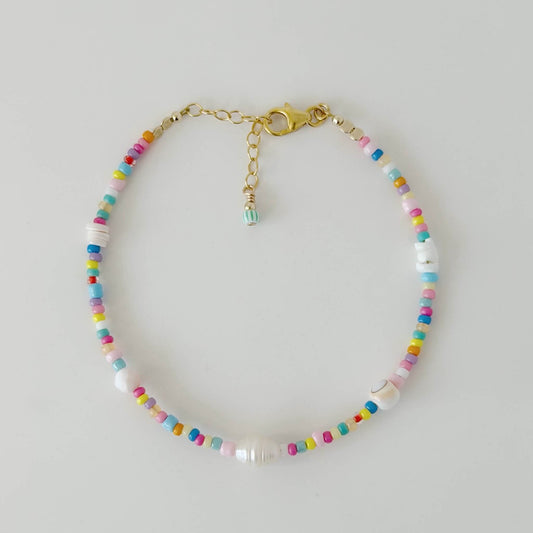 Multicolour glass bead and shell bracelet with gold fill clasp and extender chain on a white flat lay surface