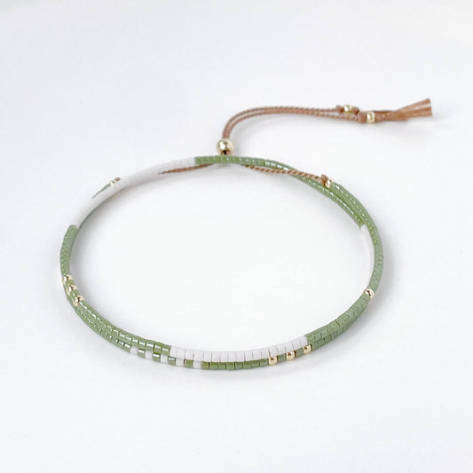 Oliva double wrap bracelet with moss green and soft white Miyuki beads and gold fill clasp on a white background