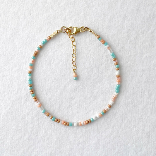 Beaded bracelet in aqua, peach, white, and golden beige with gold fill clasp—Sunrise Surf design by Hardy to Hudson