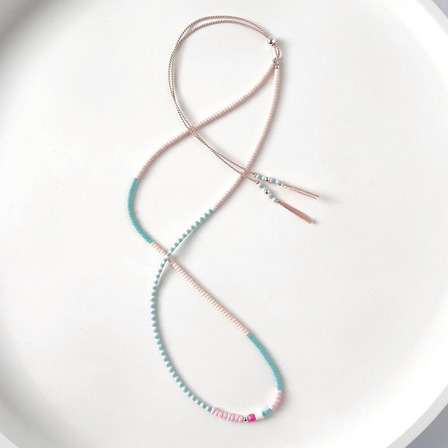 Sterling silver slider beads and colorful glass beads detail on adjustable silk cord necklace