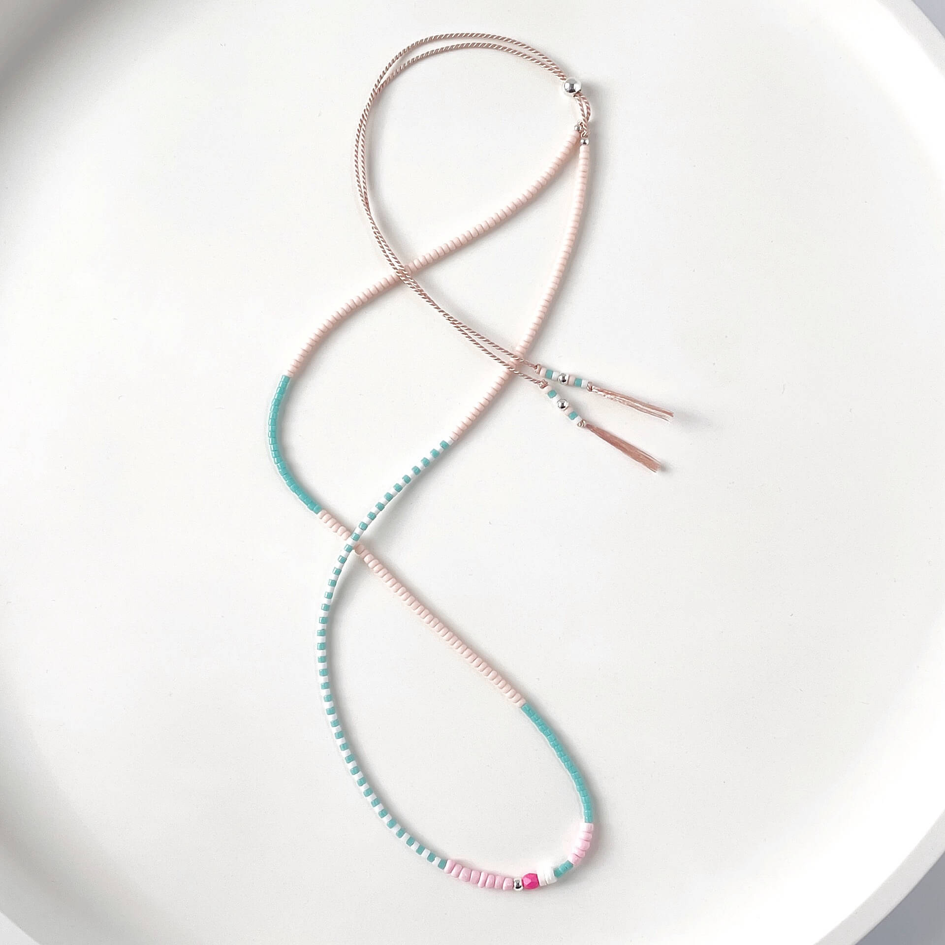 Sterling silver slider beads and colorful glass beads detail on adjustable silk cord necklace