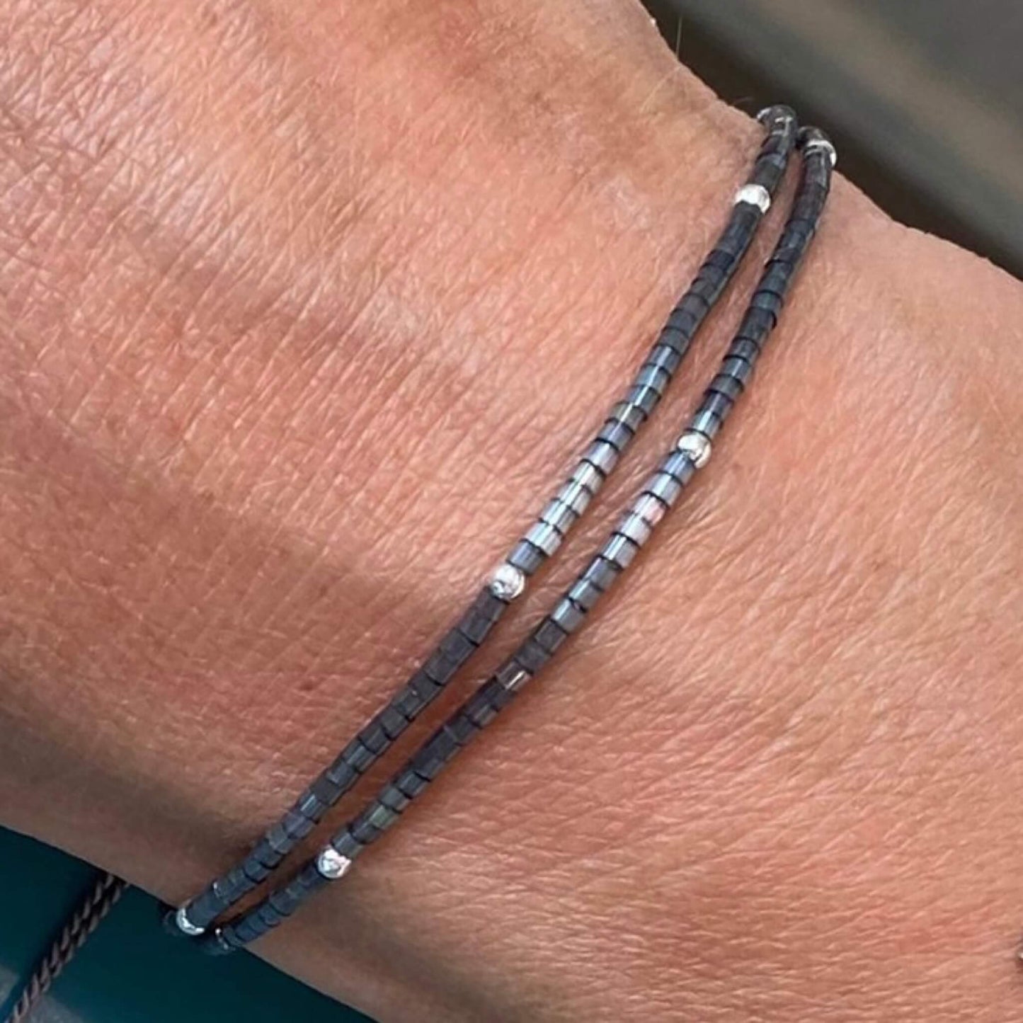 Minimal grey double wrap bracelet with sterling silver shown worn on wrist