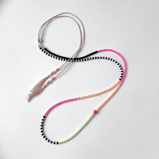 Neon pink, yellow and orange glass bead necklace with black and white beads on soft pink silk cord