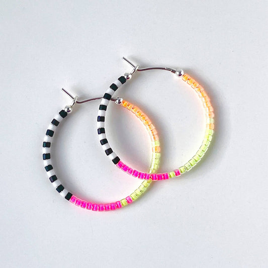 Sterling silver hoop earrings with neon pink, yellow, orange, black and white glass beads