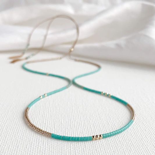 Fistral necklace with turquoise and gold Miyuki glass beads on pale blue silk