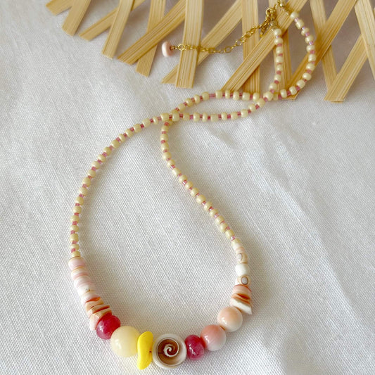 Necklace with shell beads on a white fabric background